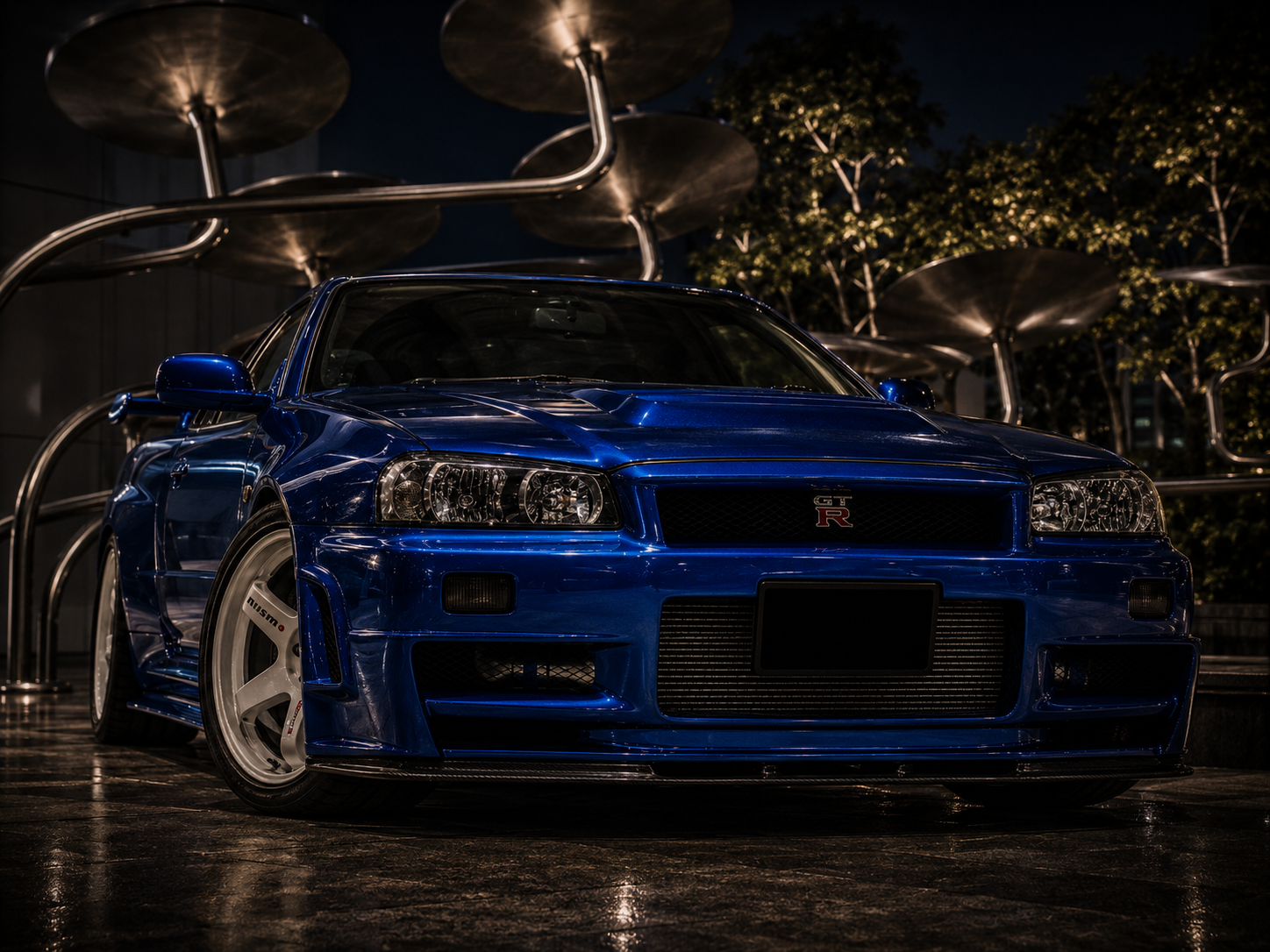 Blue Nissan Skyline GT-R R34 photographed from a low front angle